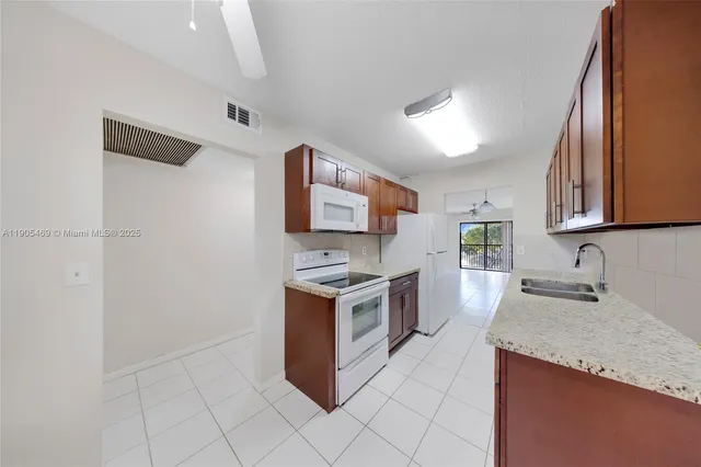 a kitchen with granite countertop a sink and a stove