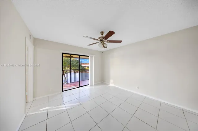 a view of a livingroom with a ceiling fan and window