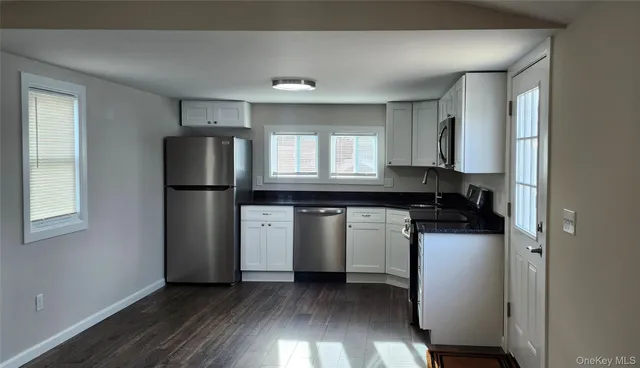 a kitchen with a refrigerator and a stove top oven