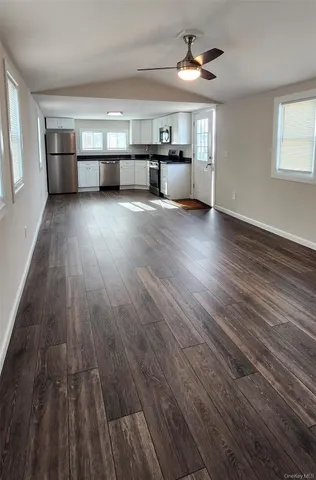 a view of a kitchen with microwave and cabinets