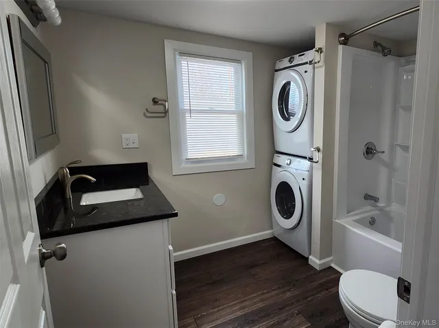 a bathroom with a sink a toilet and window