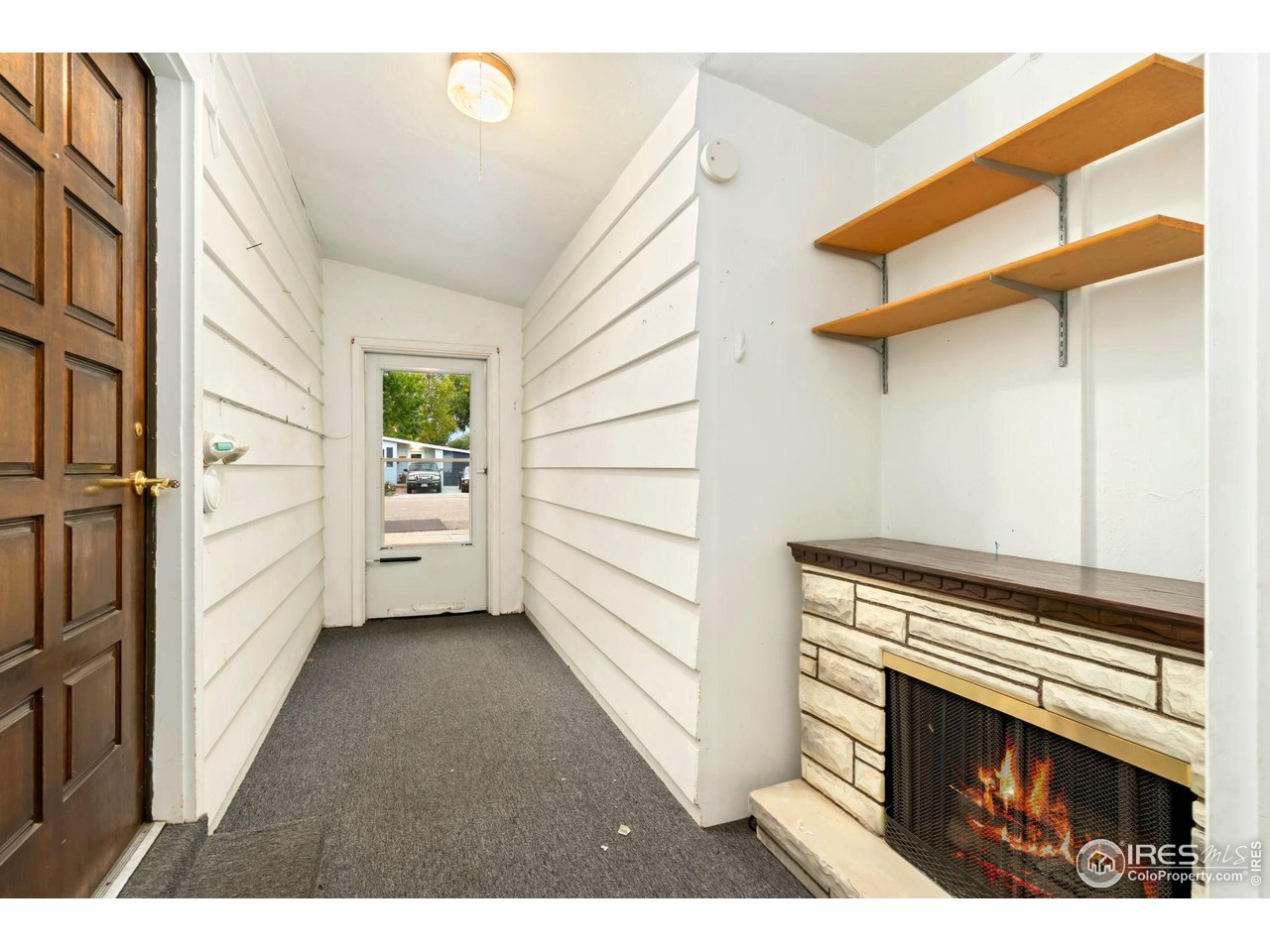 2046 26th Street Road Greeley, CO 80631 - Photo 23 of 34 a view of an empty room with a fireplace and a window