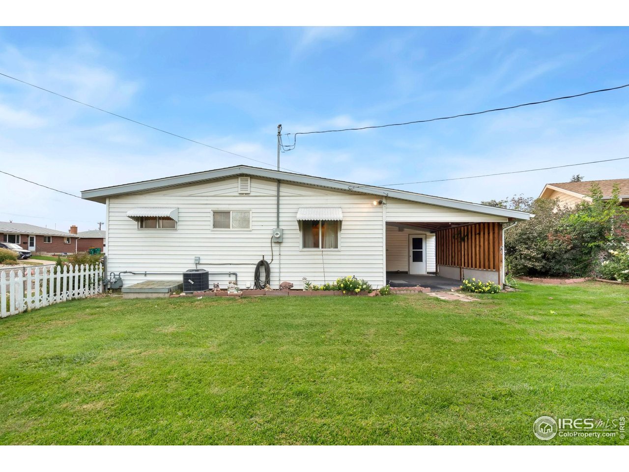 2046 26th Street Road Greeley, CO 80631 - Photo 28 of 34 a front view of a house with a garden