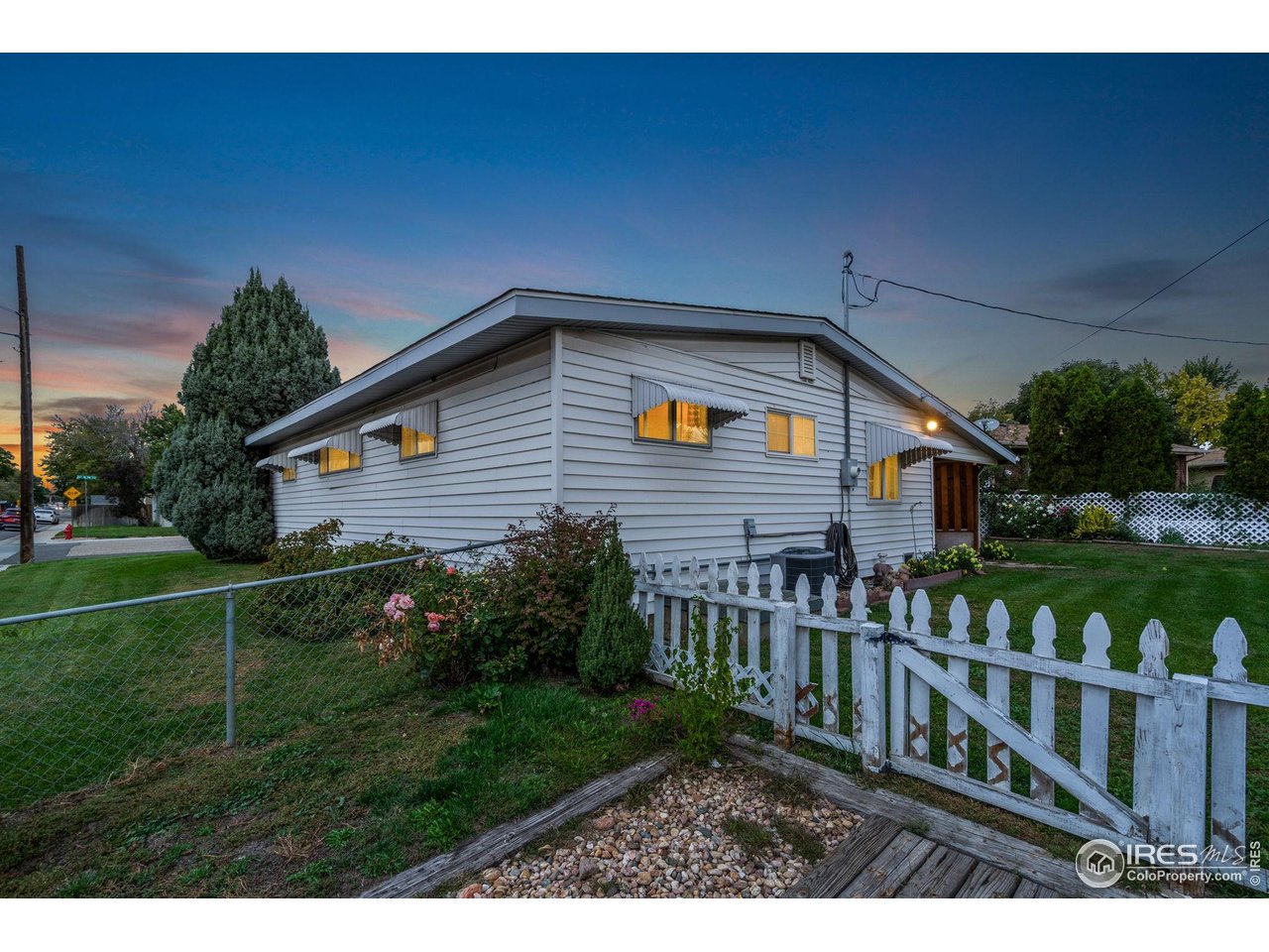 2046 26th Street Road Greeley, CO 80631 - Photo 32 of 34 a front view of house with yard and green space