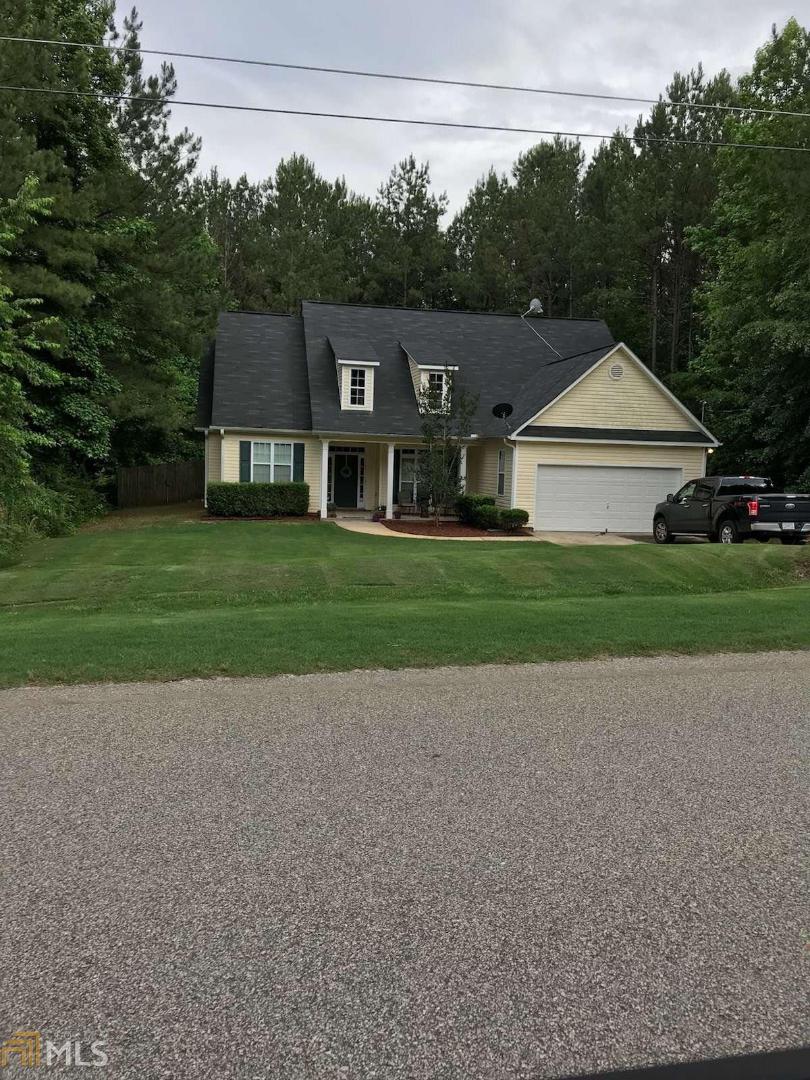 124 Jenny Road Grantville, GA 30220 - Photo 1 of 1 a front view of a house with a yard and trees