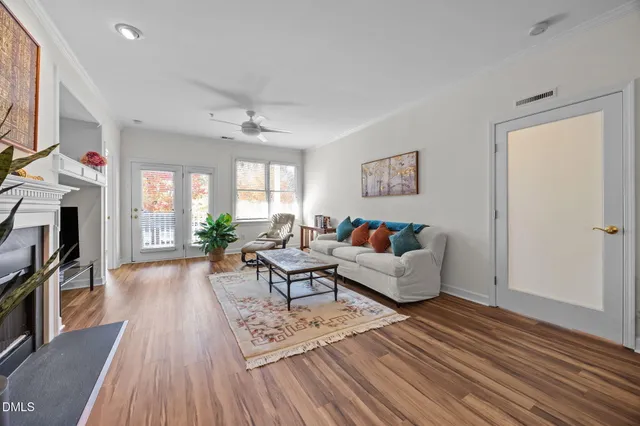 a living room with furniture fireplace and wooden floor