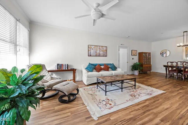 a living room with furniture rug and wooden floor