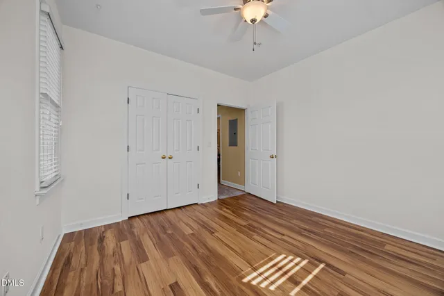 a view of an empty room with wooden floor