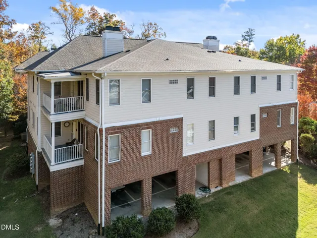 a aerial view of a house next to a yard
