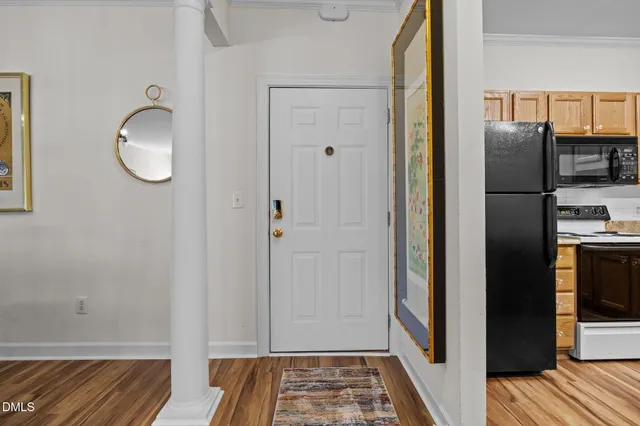 a view of walk in closet with wooden floor