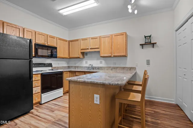 a kitchen with stainless steel appliances granite countertop a refrigerator sink and microwave