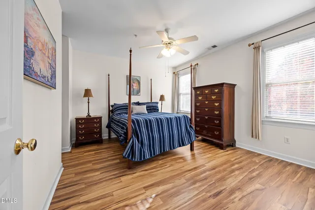 a bedroom with furniture and wooden floor