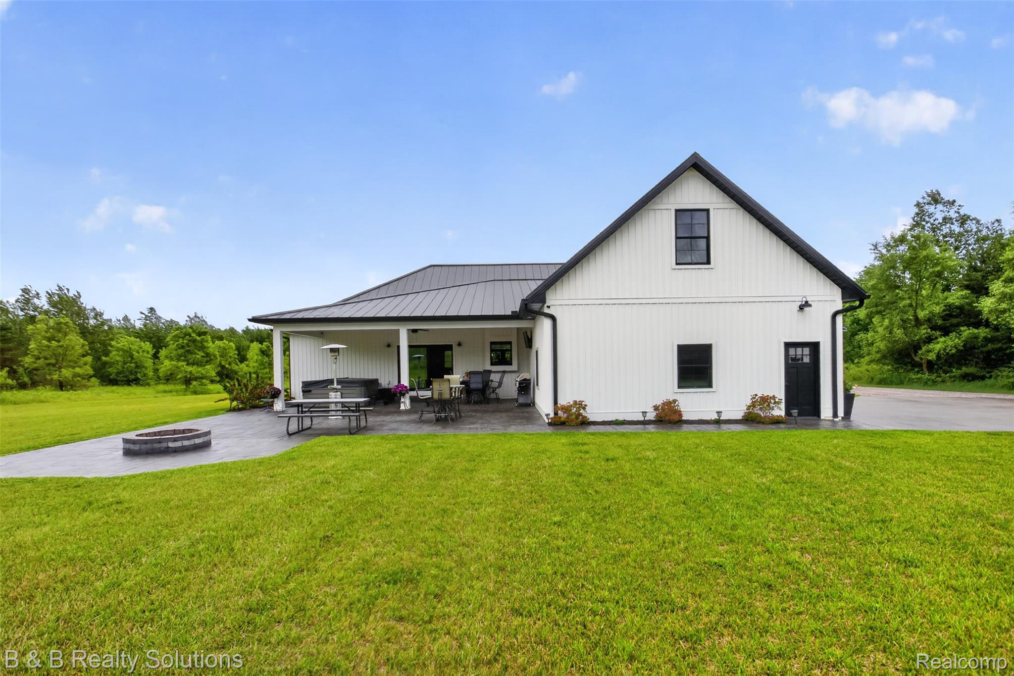 6204 Fish Lake Road North Branch, MI 48461 - Photo 56 of 79 Contemporary board and batten exterior with a dark metal roof