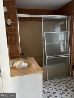 a bathroom with a granite countertop sink