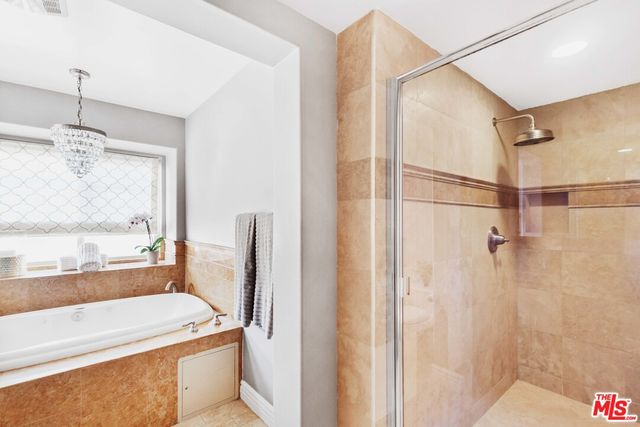 a bathroom with a tub and a shower