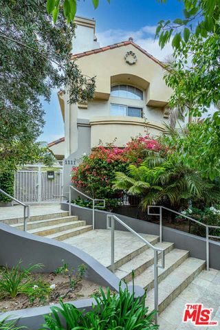 a view of a patio with table and chairs and potted plants