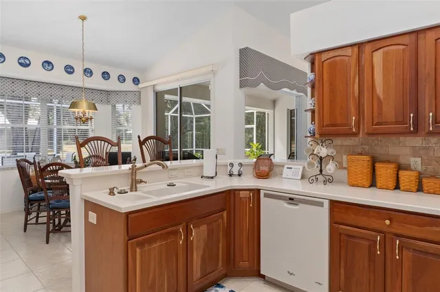 a view of a kitchen with a sink and dishwasher with wooden floor