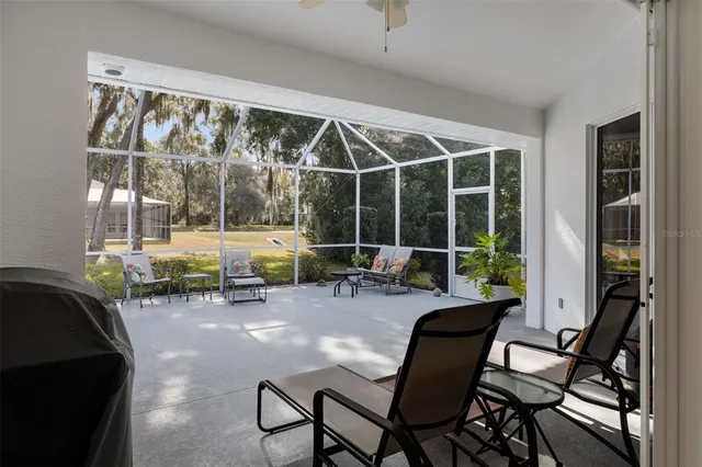 a view of a workspace with furniture and floor to ceiling window