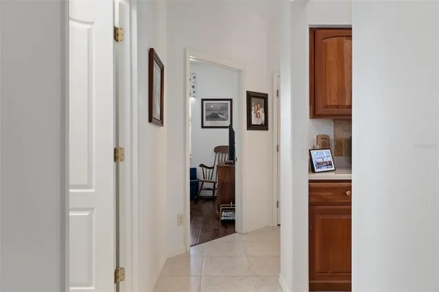 a view of a hallway with wooden floor and closet