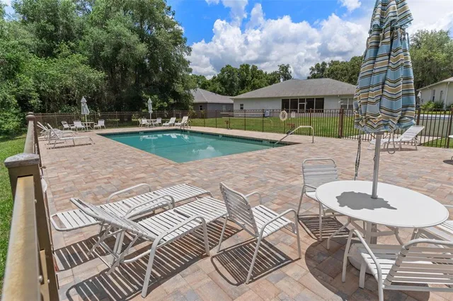 a view of a swimming pool with a patio