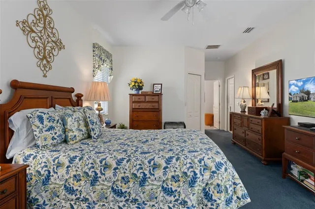 a bedroom with a large bed and a dresser