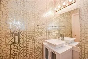 a bathroom with a sink vanity and a shower
