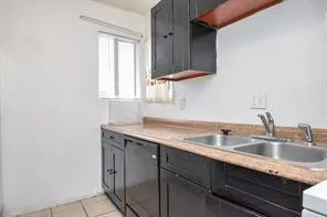 a kitchen with a sink cabinets and window