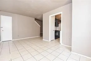an empty room with white wall and entryway