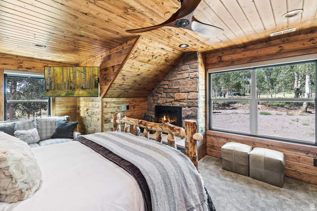2031 South Quakie Road Koosharem, UT 84744 - Photo 25 of 33 Wood-paneled walls and ceiling featuring a stone-clad fireplace