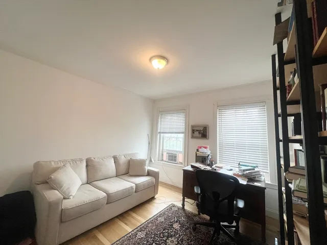 a living room with lots of furniture and a wooden floor