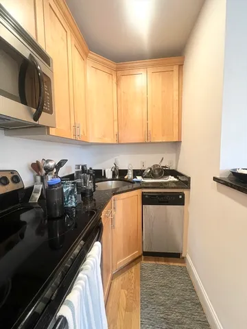 a kitchen with stainless steel appliances granite countertop a stove and a refrigerator