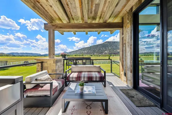 a view of a balcony with floor to ceiling windows with wooden floor