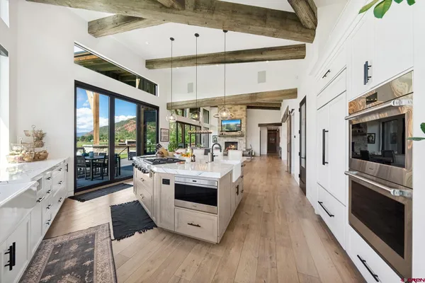 a kitchen with stainless steel appliances a stove a sink and a refrigerator
