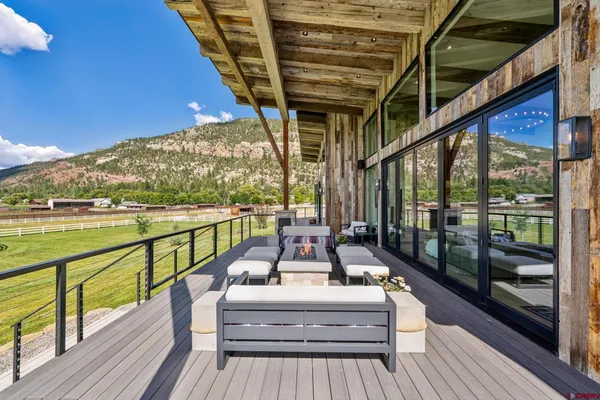 a view of balcony with furniture and wooden floor