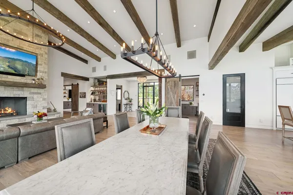 a living room with furniture a fireplace and a chandelier