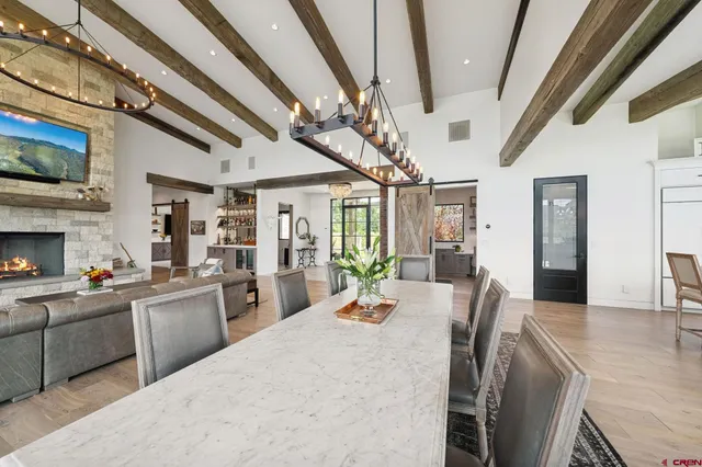 a living room with furniture a fireplace and a chandelier