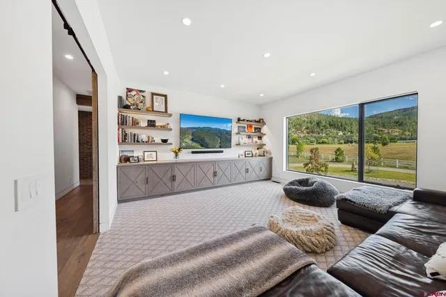 a living room with furniture and a large window