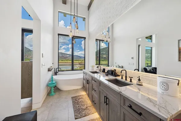 a spacious bathroom with sinks mirror and a bathtub