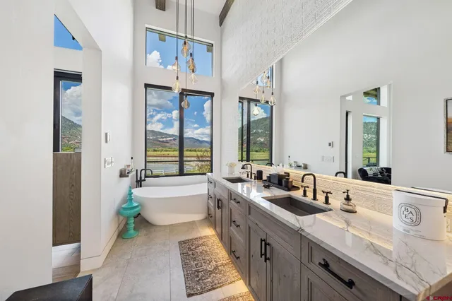 a spacious bathroom with sinks mirror and a bathtub