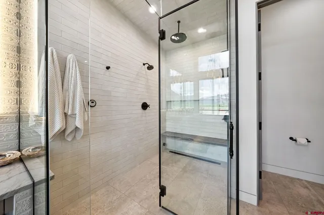 a bathroom with a glass shower door
