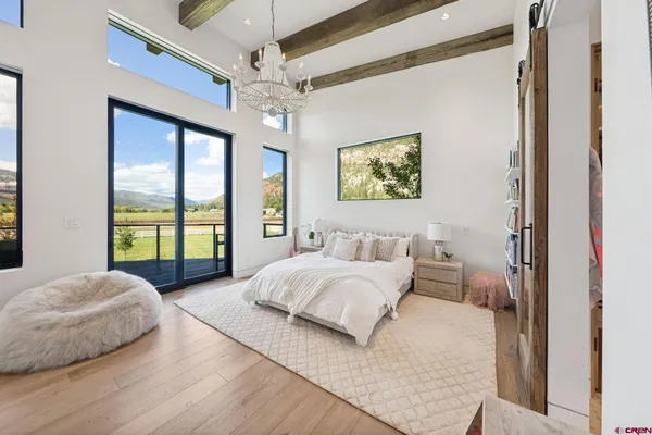 a spacious bedroom with a bed and a large window