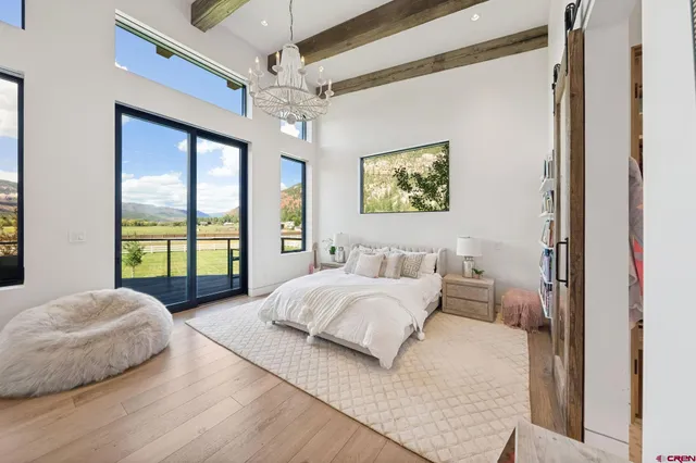 a spacious bedroom with a bed and a large window