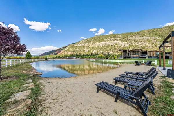 a view of a lake with couches in the patio