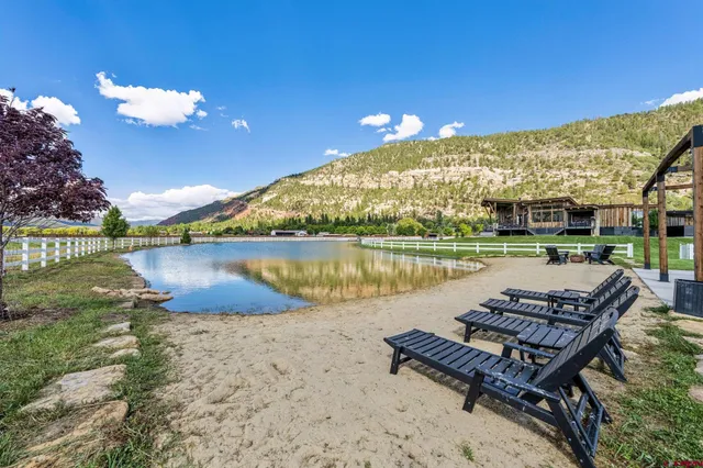 a view of a lake with couches in the patio