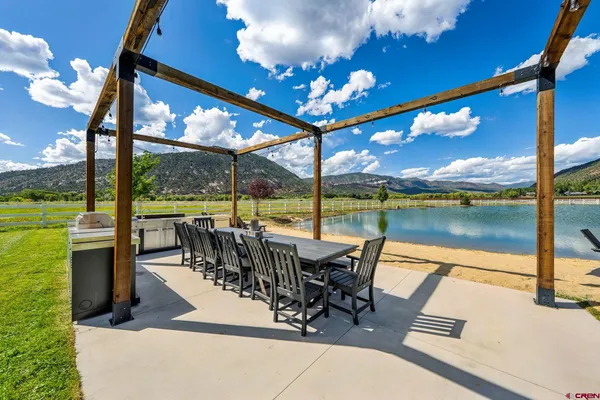 a view of a swimming pool and outdoor seating