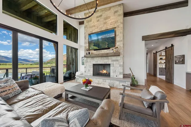 a living room with furniture fireplace and flat screen tv