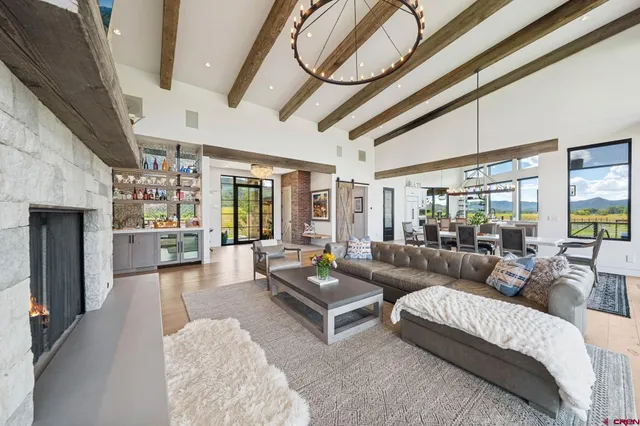 a living room with furniture a ceiling fan and a rug