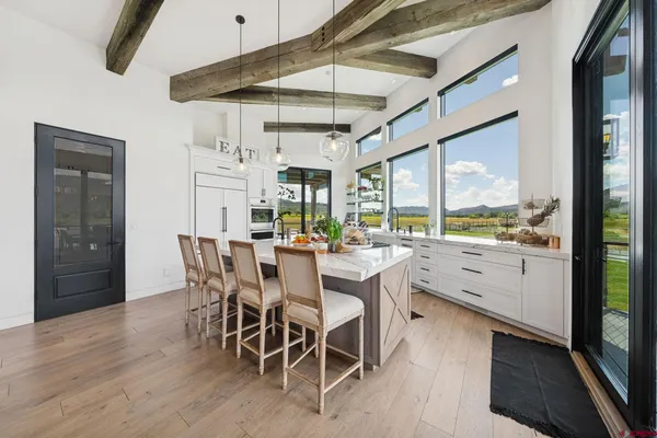 a view of a dining room with furniture window and wooden floor