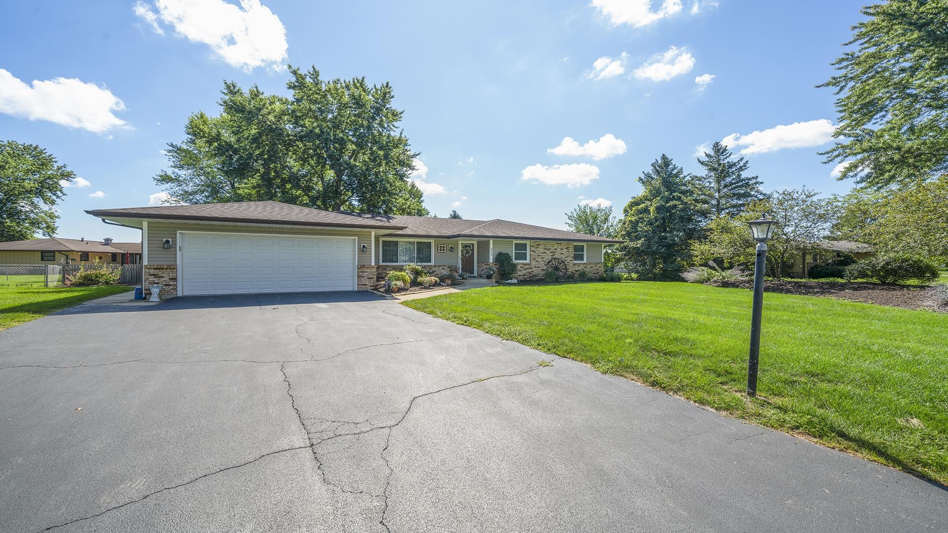 3920 Cutty Sark Road Cherry Valley, IL 61016 - Photo 3 of 30 a front view of house with yard and green space