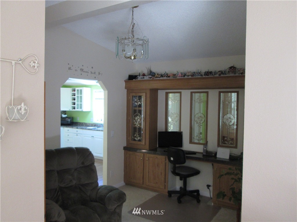 18905 Rouse Road Southwest Longbranch, WA 98351 - Photo 12 of 25 a living room with furniture and a chandelier